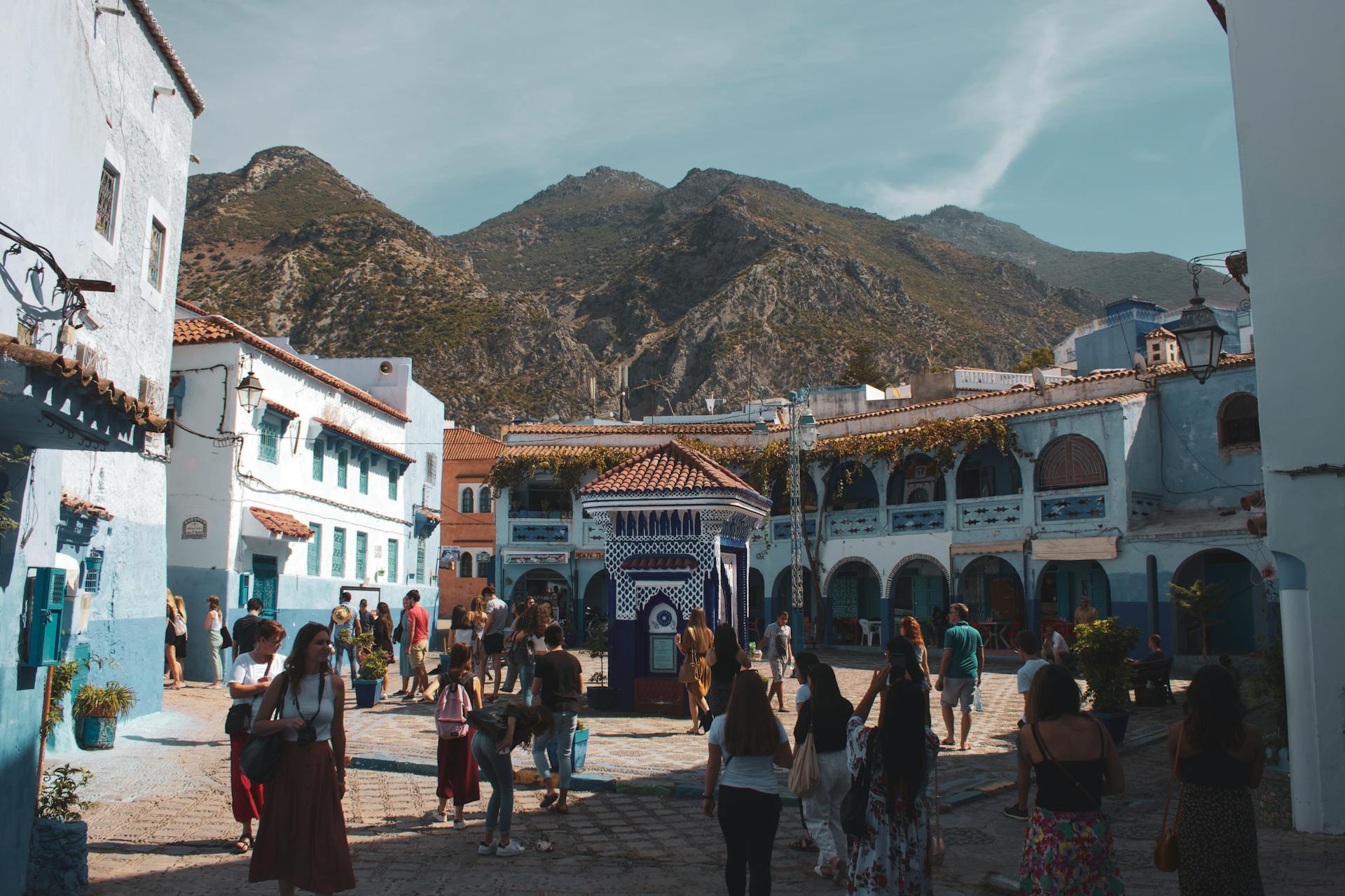 A traveler looking over the blue streets of the Medina of Chefchaouen Morocco.