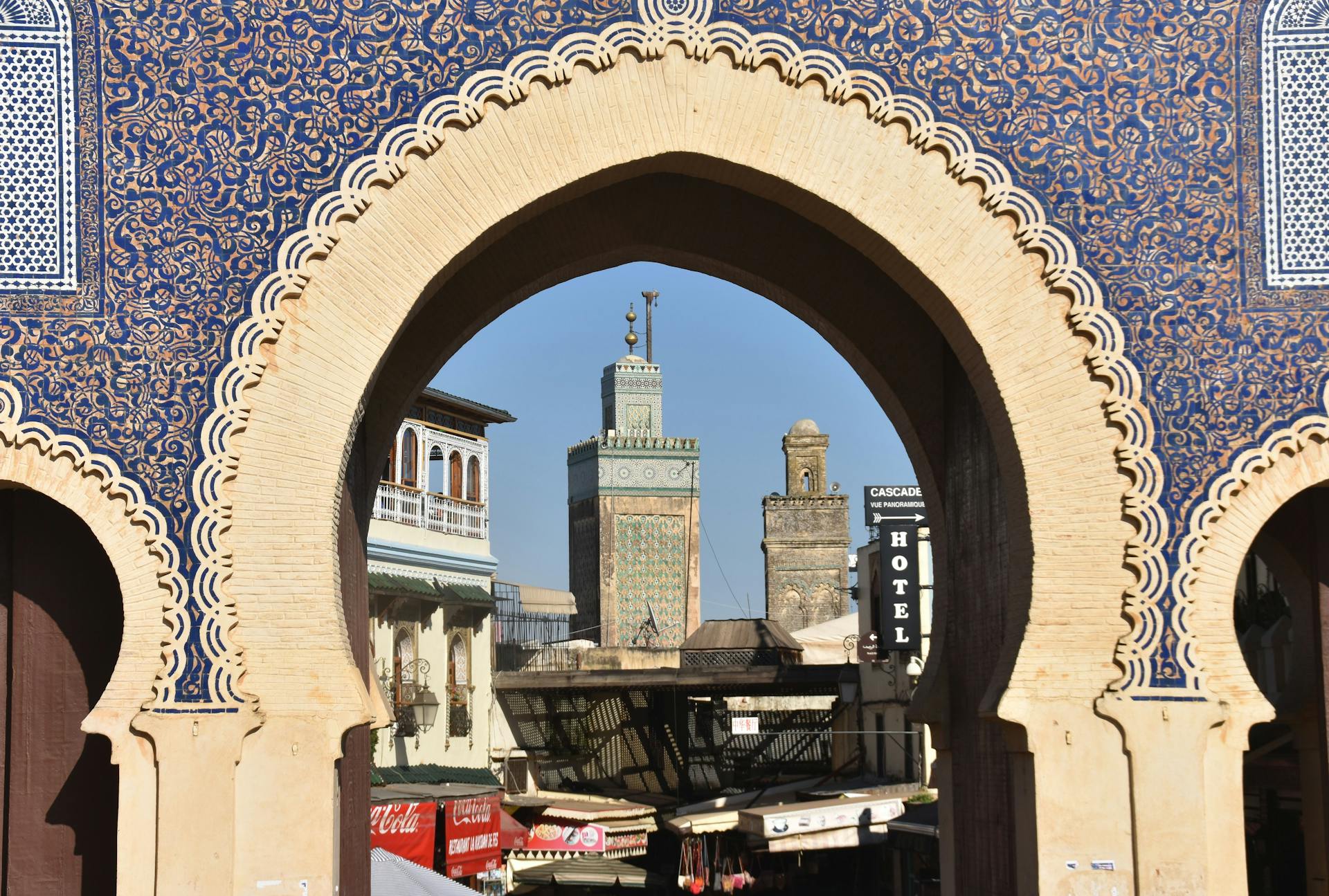 A CTM bus and a white Grand Taxi at the station ready for the trip from Fes to Chefchaouen.